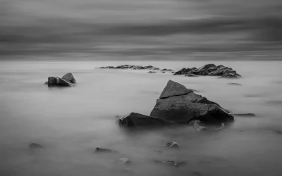 a large rock in the fog