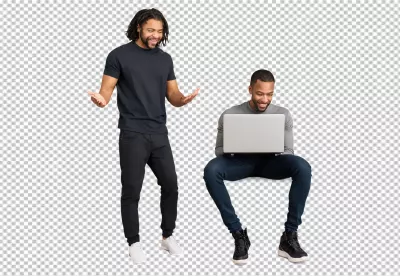 Two Happy Young African American Men Engaging with Laptop on White Background image