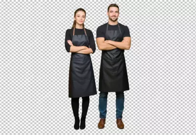 Smiling Professional Man and Woman in Black Aprons Posing Confidently with Arms Crossed image