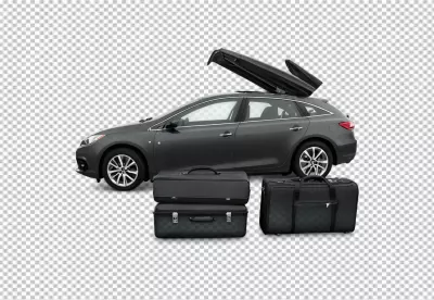 Modern grey station wagon with open roof cargo box and suitcases ready for travel image