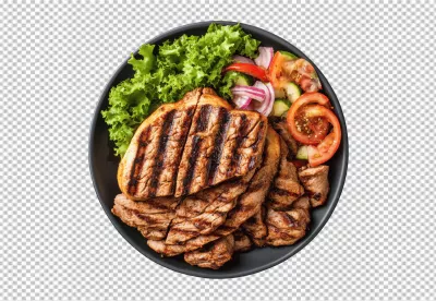 Delicious Grilled Meat with Fresh Mixed Salad on Black Plate PNG Cutout image