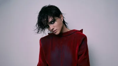 Captivating Young Woman with Wet Hair and Intense Gaze in Red Top Studio Portrait image