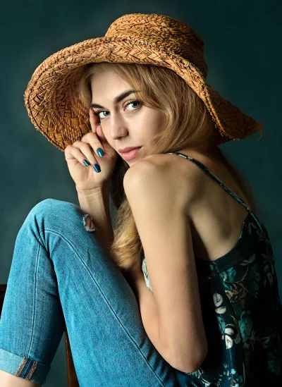 Young Woman with Straw Hat and Blue Jeans Posing in Studio Portrait image