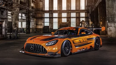 Sleek Orange Mercedes-AMG GT3 Racing Car in Atmospheric Abandoned Factory image