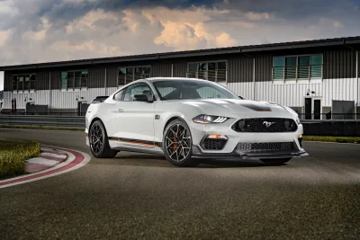 White Ford Mustang Mach 1 on Racetrack with Dramatic Sky image