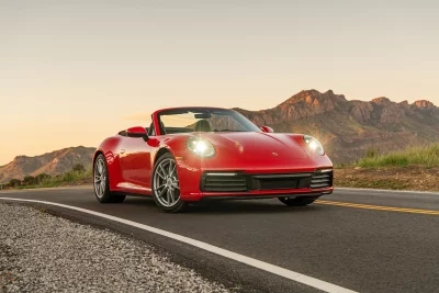 High-Performance Red Luxury Convertible Driving Scenic Mountain Road image