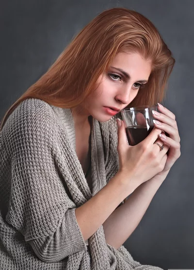 Contemplative Redhead Woman in Knit Cardigan with Dark Beverage image