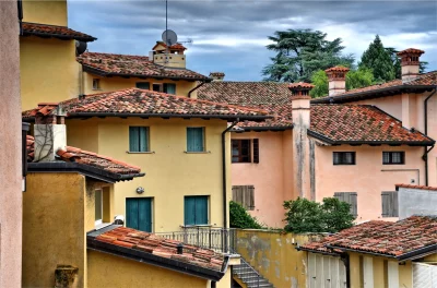 Old European Townhouses with Terracotta Roofs and Pastel Walls image