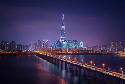Seoul Cityscape at Night with Lotte World Tower and Illuminated Bridge over Han River image
