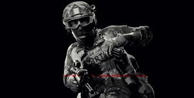 Special Forces Soldier in Camouflage Gear with Rifle and Red Laser Sight image