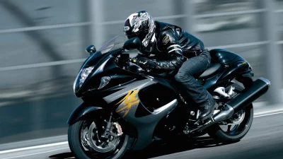 Dynamic High-Speed Motorcycle Rider on Black Sportbike with Motion Blur image