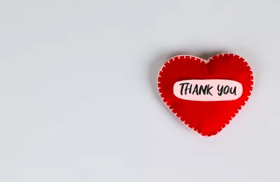 Expressing Gratitude: Red Felt Heart with 'Thank You' on Minimal White Background image