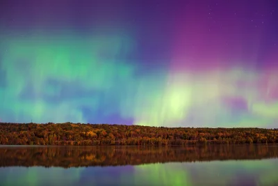 Vibrant Aurora Borealis Reflecting Over Autumn Forest Lake at Night image