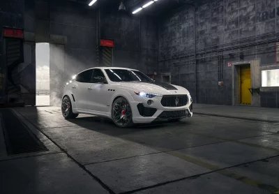 Sleek White Maserati Levante SUV in Moody Industrial Hangar with Dramatic Lighting image