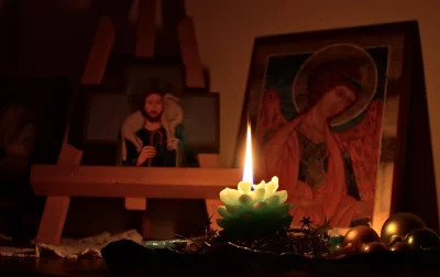 Warm Glow of Flower Candle Illuminates Orthodox Icons with Ornaments image