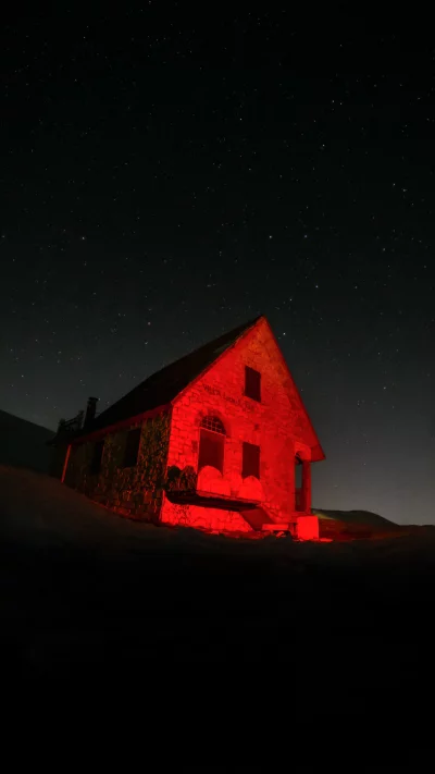 Isolated Stone Building Glowing Red Under a Star-Filled Night Sky image