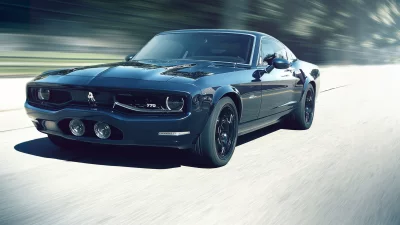 Sleek Dark Blue Classic Muscle Car Speeding on a Blurry Road image