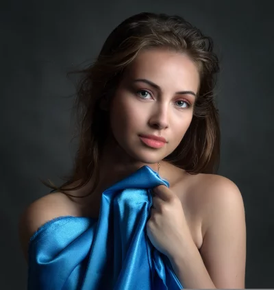 Elegant Woman Draped in Blue Satin Looking at Camera image