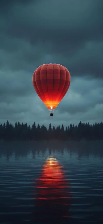 Red hot air balloon over dark lake and forest at dusk