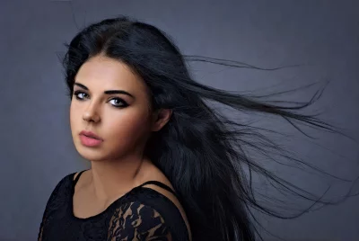 Elegant Woman with Flowing Black Hair and Striking Eyes Portrait image