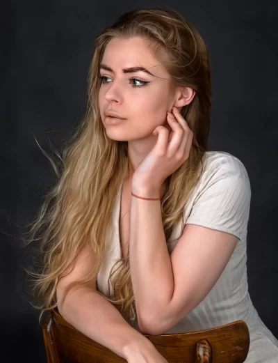 Pensive Young Woman with Long Blonde Hair in Studio Portrait image