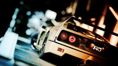 Iconic Ferrari F40 Sports Car Driving Through Blurry City Lights at Night image