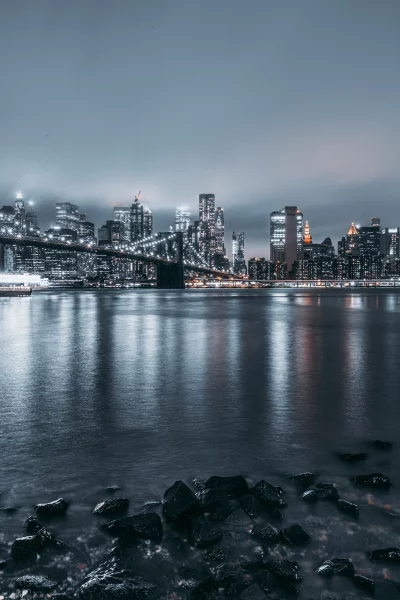 New York City Skyline Night View with Brooklyn Bridge Reflections and Urban Glow image