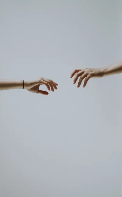 two hands reaching out to each other