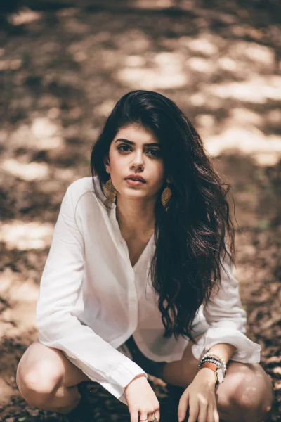 Beautiful Young Woman Crouching Outdoors Posing Serene Stock Photo for Download image