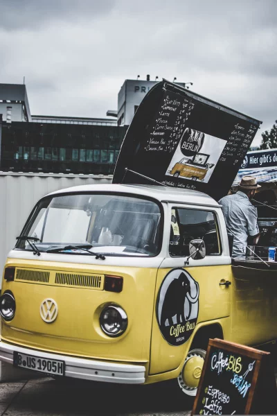 a yellow and white Volkswagen bus that has been converted into a coffee shop
