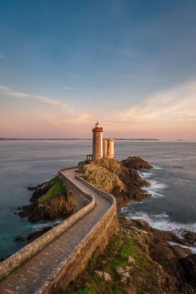 Scenic Lighthouse at Sunrise with a Winding Stone Path