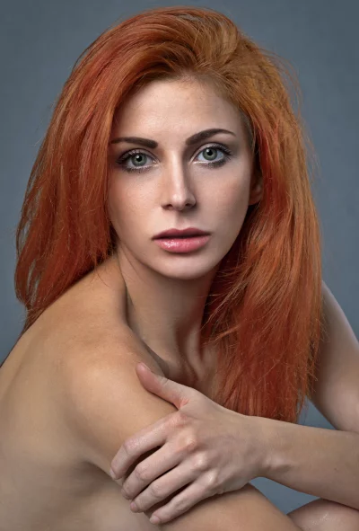 Vibrant Redhead Woman with Green Eyes and Pensive Gaze Portrait image