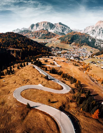 Aerial View of Winding Mountain Road in Autumn Dolomites with Village image