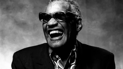 Legendary Soul Musician Ray Charles Laughing Heartily in Black and White Portrait image