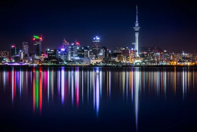Mesmerizing Auckland City Skyline at Night with Vibrant Reflections on Calm Water image