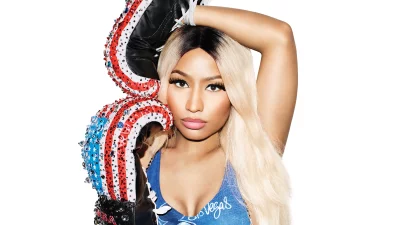 Nicki Minaj in Blue Top with Bejeweled Boxing Glove Posing Confidently image