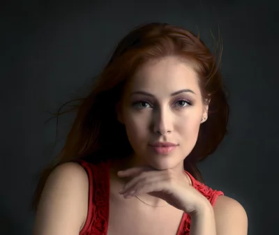 Pensive Young Woman with Red Hair and Textured Red Top image