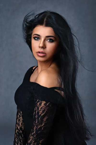 Captivating Woman with Long Flowing Hair in Black Lace Top image