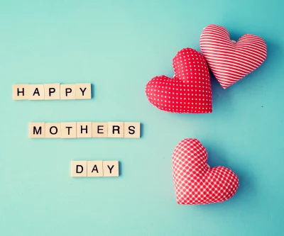 Heartfelt Happy Mother's Day Message with Decorative Red Patterned Hearts on Blue image
