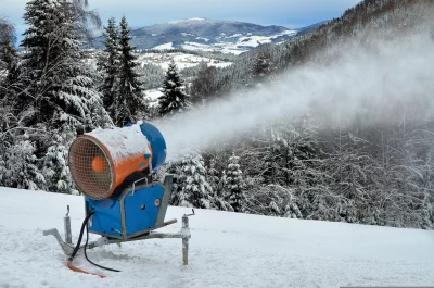 Snow Cannon Generating Artificial Snow on Pristine Winter Mountain Ski Slope image