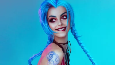 Jinx Cosplay with Vibrant Blue Braids, Striking Red Eyes, and Mischievous Smile image