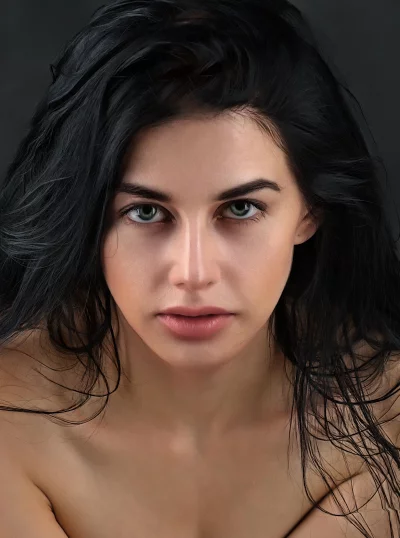 Striking Portrait of Young Woman with Wavy Dark Hair and Piercing Gaze image