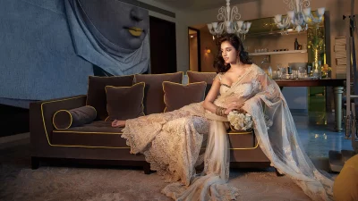 Elegant Indian Woman Lounging in Ornate White Saree on Luxury Sofa image