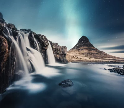 Breathtaking Kirkjufell Waterfall and Aurora Borealis Under Starry Night Sky Cinematic Landscape Wallpaper image