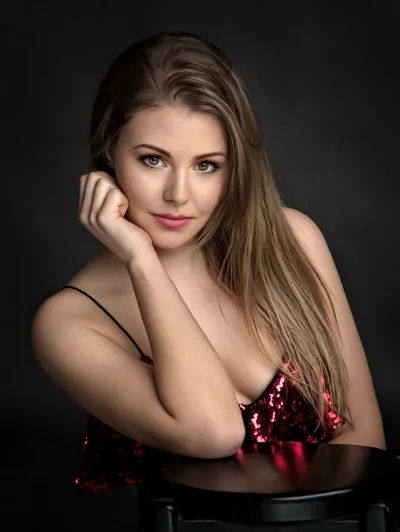 Confident Young Woman in Sparkling Red Sequin Top, Dark Background image