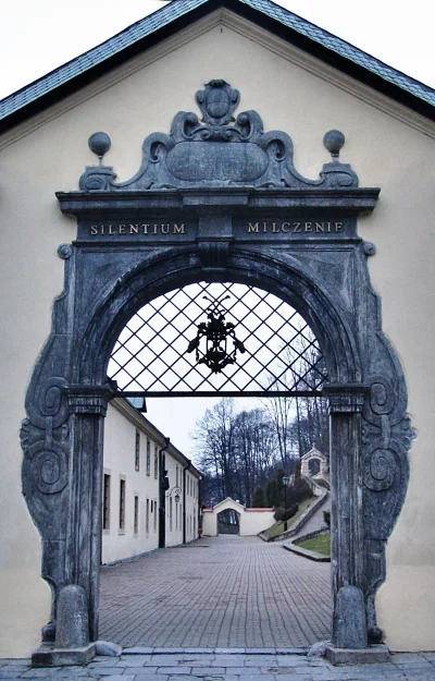 Grand Stone Archway with 'Silentium Milczenie' Inscription at Historic Monastery Entrance image