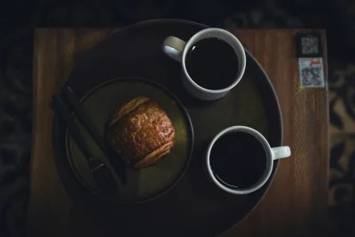 Cozy coffee break with a pastry and two cups of coffee
