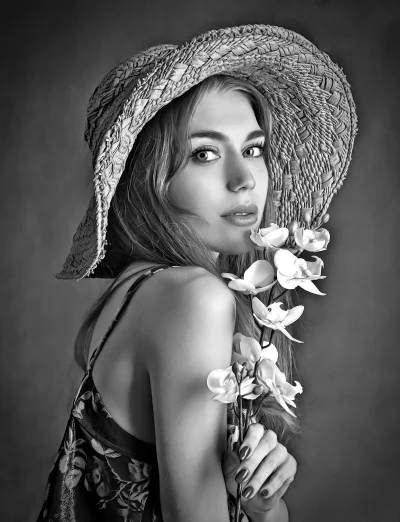 Elegant Young Woman in Straw Hat with Orchids Black and White Portrait image