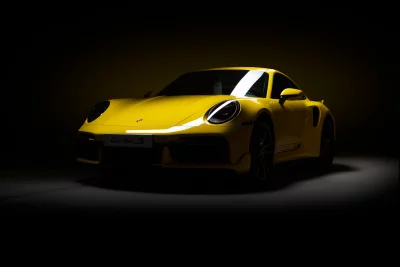 High-Performance Yellow Porsche 911 Turbo S in a Dark Studio Environment image