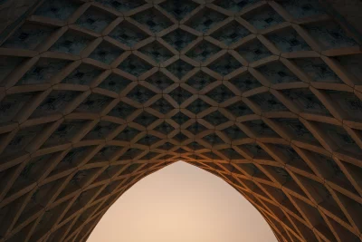Intricate Geometric Archway Against a Softly Lit Sky at Sunset
